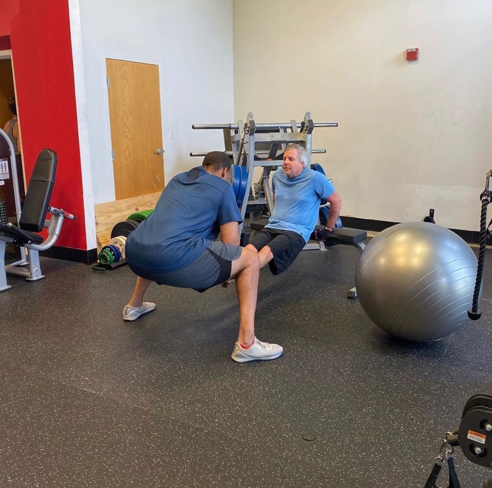 Ed Chester guiding a client through stability ball exercises